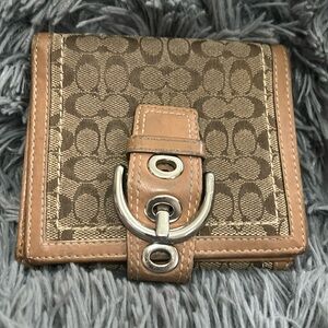 Coach Wallet with Buckle Detail.